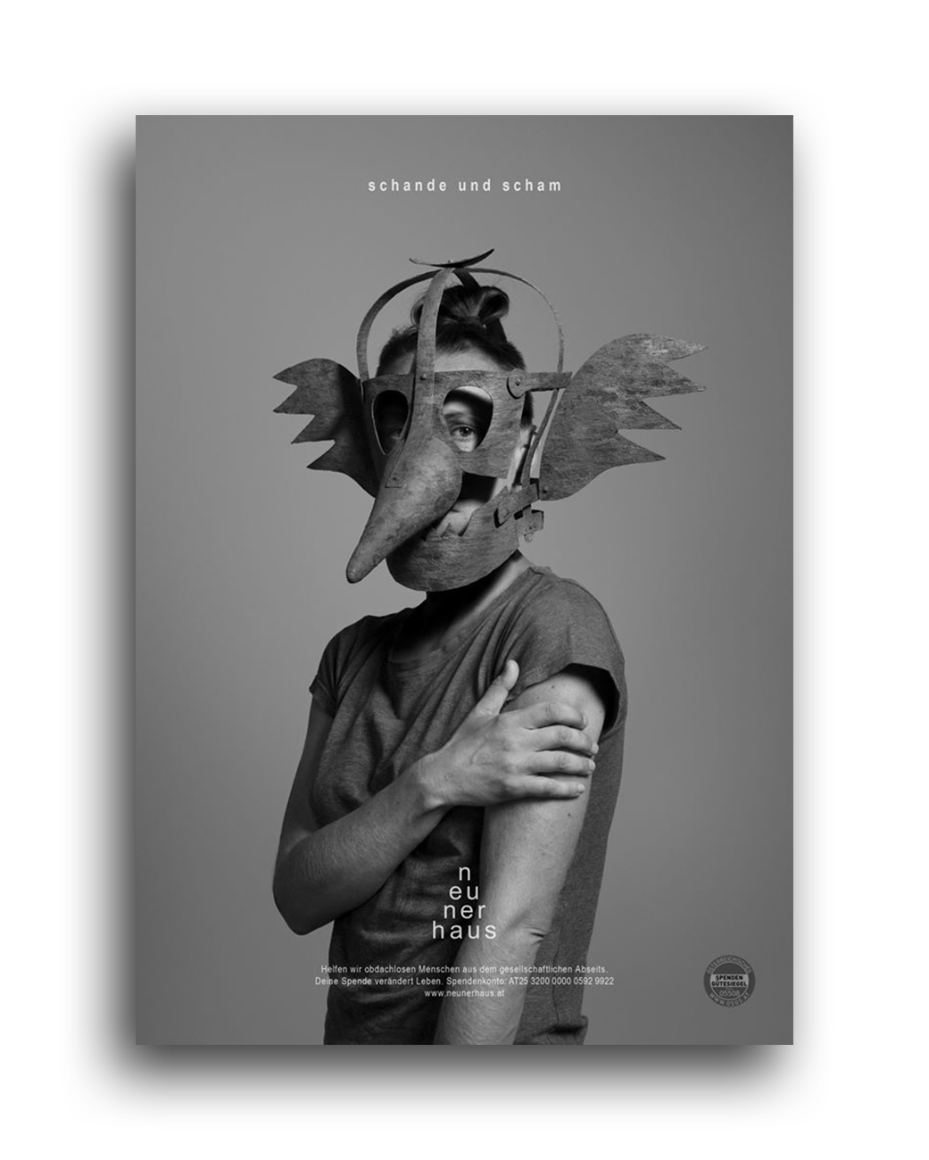 Bernd Preiml, Denis Mujakovic, campaign for neunerhaus, black and white photo of a man wearing a medieval iron mask of shame